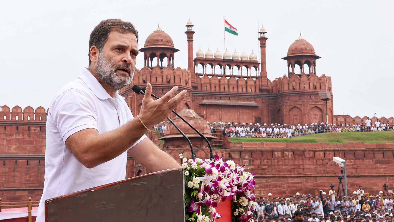 Rahul Gandhi speaking at a podium before the Red Fort, New Delhi